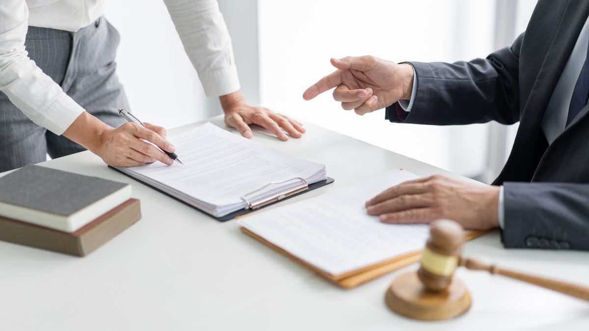 Lawyer reviewing legal documents with source materials